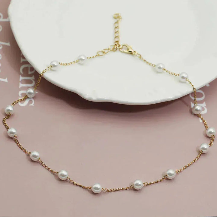 Layered Gold Necklace Adorned with a Pearl Accent